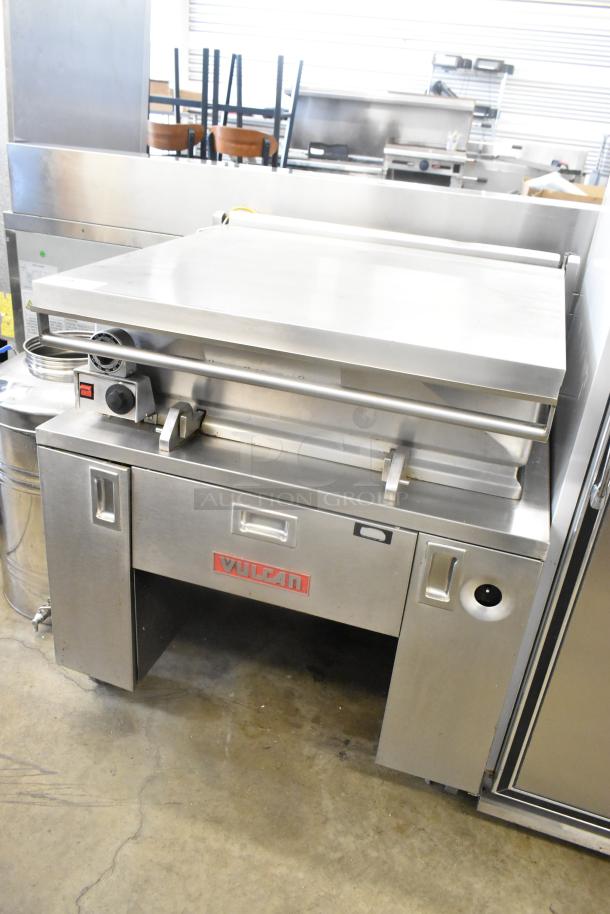 Vulcan stainless steel commercial braising pan, floor style, with commercial casters. Features control dials and Vulcan logo.