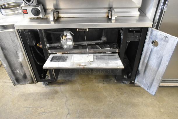 Vulcan stainless steel commercial braising pan, floor style with casters. Includes controls and interior view. Used condition.