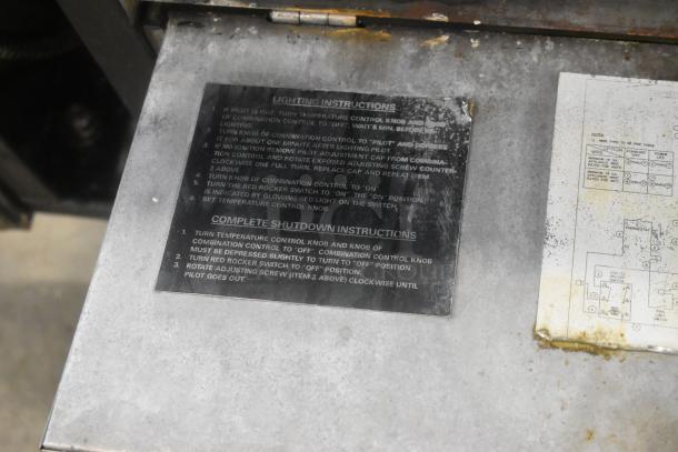 Vulcan stainless steel commercial braising pan with visible lighting and shutdown instructions on metal panel.