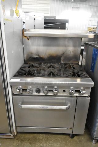 Cookrite stainless steel 6-burner gas range with oven, over-shelf, and backsplash on casters. Used condition.