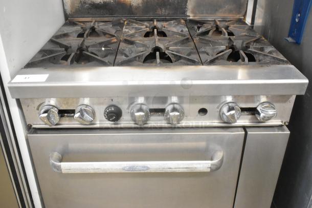 Cookrite stainless steel 6-burner gas range with oven, over shelf, backsplash, on casters. Used condition.