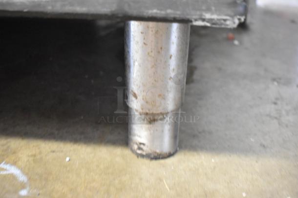 Stainless steel leg of Manitowoc IY1106A-261 commercial ice head on ice bin. Shows wear, suitable for 208-230V, 1 phase.