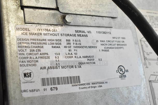 Stainless steel Manitowoc IY1106A-261 commercial ice maker label; 208-230 volts, 1 phase, model and specs visible.