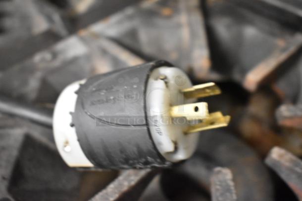 Alt text: Close-up of a power plug for the Manitowoc IY1106A-261 stainless steel commercial ice head, showing three prongs.
