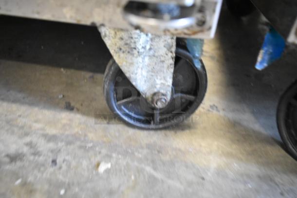 Dukers DSP60 prep table on commercial caster, stainless steel, shows signs of use.