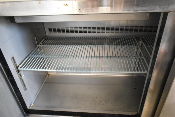 Dukers DSP60 commercial prep table interior with wire shelf. Stainless steel, bain marie top, 115V, on casters, good condition.