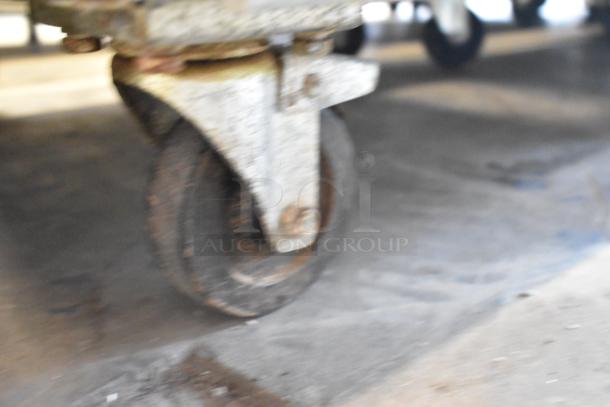 Rusty caster wheel of Polar GE004 Stainless Steel Commercial Cooler, showcasing wear. Model features poly coated racks.