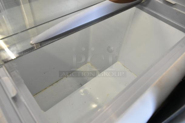 Avantco 360ADC4HC metal commercial chest freezer interior, showing clean white compartment. Ideal for merchandising on casters.