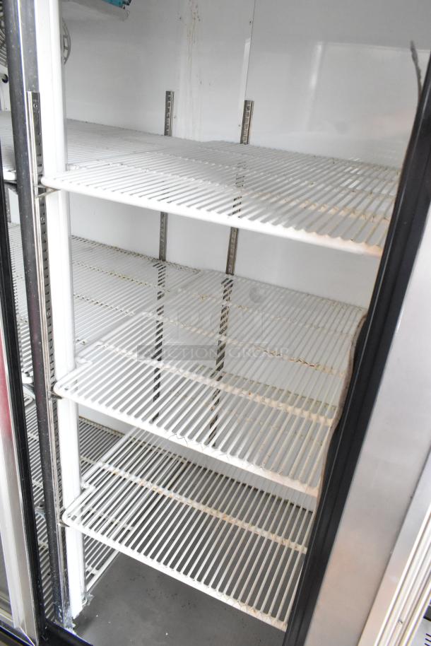 Leader LS96S S/C 4-door reach-in cooler merchandiser with poly-coated racks, in good condition. 115 volts, 1 phase.
