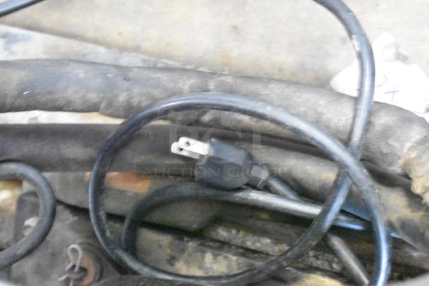 Power cord for Leader LS96S S/C 4 Door Cooler Merchandiser, showing standard plug and coiled cable condition.
