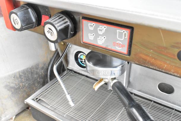 Wega Formula EVO 3 espresso machine, stainless steel, 3-group, 2 steam wands, displayed portafilters. Controls and dials visible.