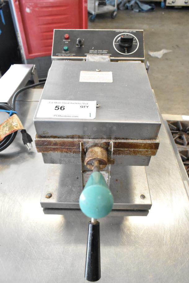 Gold Medal 5024 metal commercial countertop waffle maker, 120 volts, 1 phase, with visible wear and rust, auction tag attached.