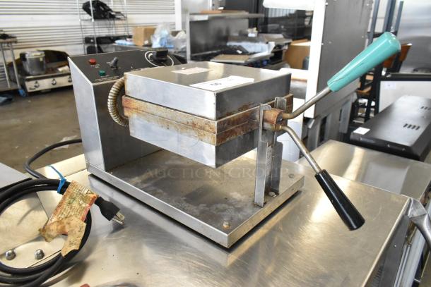 Gold Medal 5024 metal waffle maker, commercial countertop model; shows wear; 120 volts, 1 phase; includes power cord.