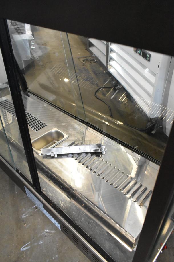 2023 Avantco 177HDC48 metal countertop heated display case. Features glass doors, stainless interior, 120 volts, 1 phase. Appears in good condition.