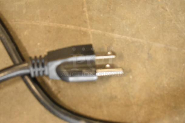 Close-up of a standard two-prong power plug attached to a cord, part of the 2023 Avantco 177HDC48 heated display case.