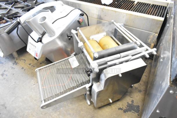 Metal countertop sheeter with dual rollers, stainless steel finish, and mesh conveyor. Excellent condition, ideal for baking.