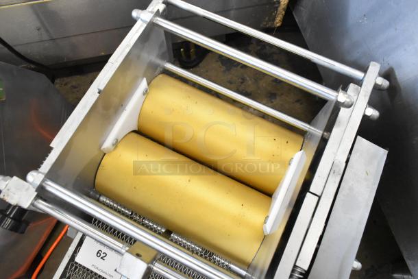 Metal countertop sheeter with dual gold rollers and sturdy frame, suitable for dough flattening. Good condition.