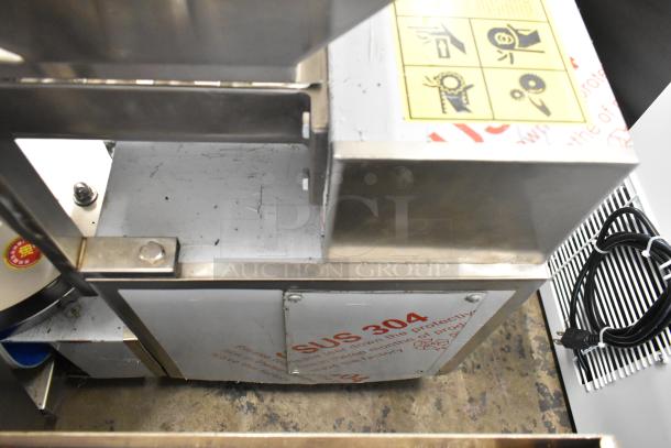Stainless steel commercial unit on casters with MNMRV40 gear reducer, SUS 304 marking, and attached power cord.