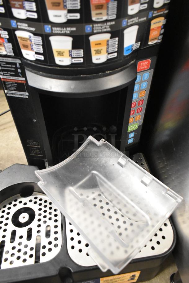 Taylor X83684-12 frozen drink mixing machine, commercial countertop model. Features control panel, cup graphics. Used condition.