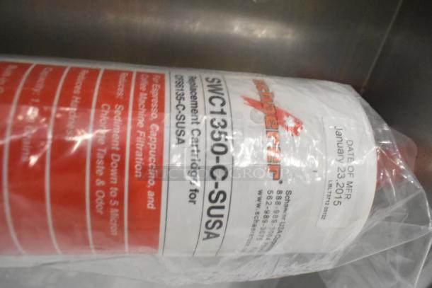 2 Schaerer SWC1350-C-SUSA replacement cartridges in packaging, labeled for espresso machine filtration, manufactured Jan 23, 2015.