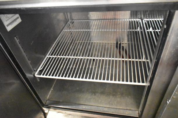 2018 Atosa MPF8202GR stainless steel commercial prep table interior view. Includes shelving, commercial casters, 115 volts, 1 phase.