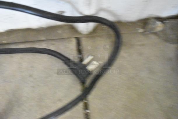 Blurred image of a power cord. No visible features of the Atosa MPF8202GR prep table are shown.