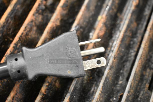 Estella 34BDPC18T dough press plug, 240V, 1-phase. Shown on a grill surface, dual prong with grounding pin, fair condition.