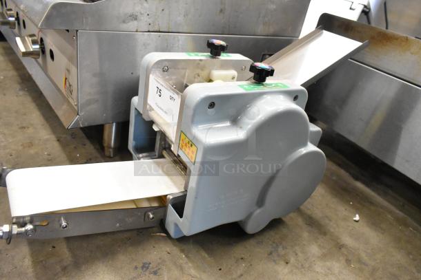 Metal commercial countertop sheeter with adjustable knobs, conveyor belt, and label. Appears in used condition.