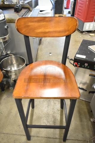 Black metal bar height chair with wooden backrest and seat. High-quality finish, sturdy construction. Offer includes four chairs.
