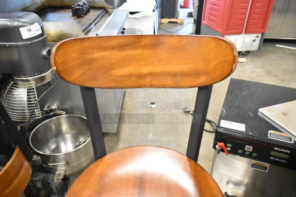 4 black metal bar height chairs with wooden back and seat, excellent condition, visible auction tags.