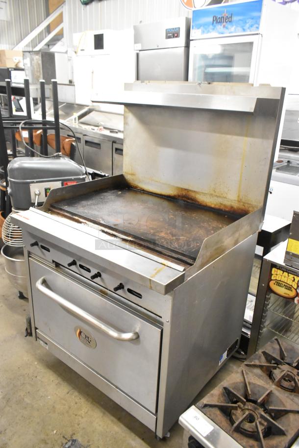 Stainless steel Cooking Performance Group 351S36G36N flat top griddle with oven, over shelf, back splash, on casters. 120,000 BTU.