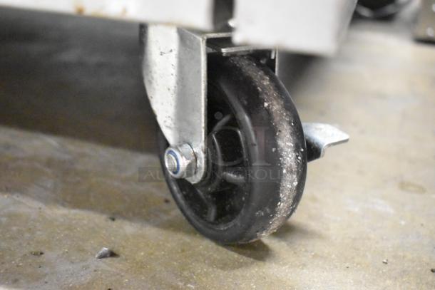 Close-up of a commercial caster wheel attached to the Cooking Performance Group 351S36G36N griddle.