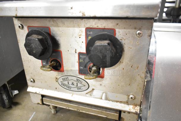 L&J stainless steel gas-powered 2 burner range, showing control knobs and label, used condition.