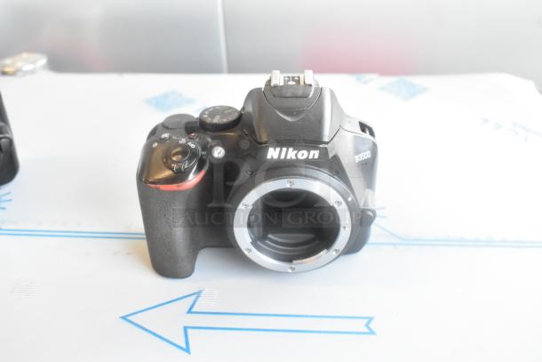 Three Nikon D3500 camera bodies and one Nikon AF-P Nikkor 18-55mm lens, excellent condition, shown without lens attached.