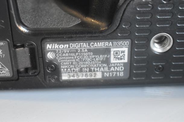 Nikon D3500 camera underside showing branding, model details, and manufacture labeling. Made in Thailand.