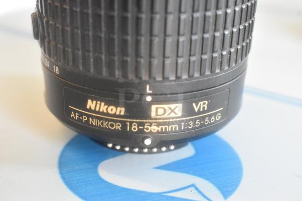Nikon AF-P Nikkor 18-55mm 1:3.5-5.6G lens, black, with visible branding and specifications.