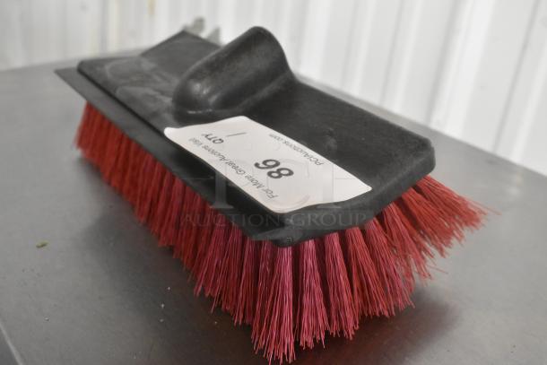 Brand new broom head with red bristles, minor scratches, and dents. Label marked "86." Ideal for DIY projects.