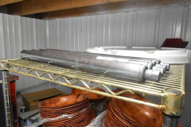 Lot of 4 brand new metal legs with minor scratches and dents, stacked on a shelf. Appears durable, high-use potential.