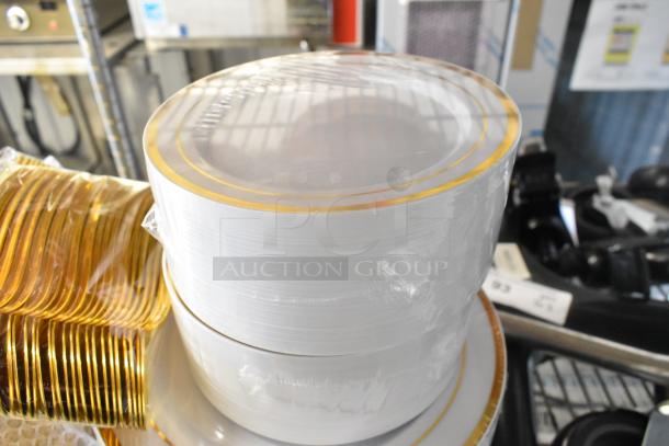 Lot of various new paper plates and plasticware with gold trim, in excellent condition. Ideal for events or parties.