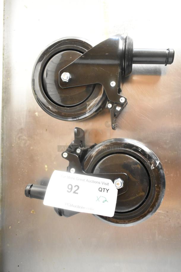 Lot of 2 brand new commercial casters with minor scratches. Black, sturdy design, labeled "QTY x2."