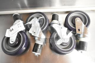 Lot of 4 brand new commercial casters with minor scratches. Features swivel design, locking mechanism, and durable wheels.
