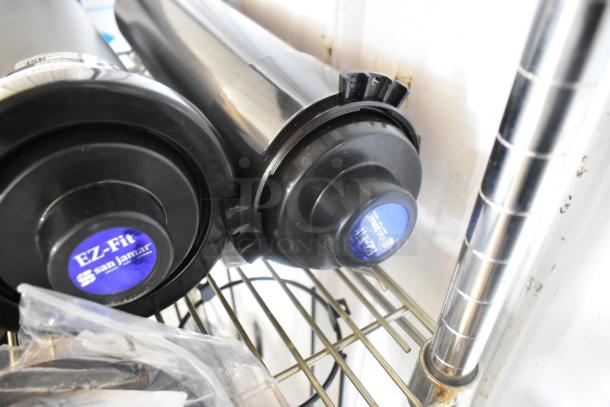 Brand new San Jamar C2210 EZ Fit cup dispensers, two units, black, scratch and dent condition, visible blue labels.