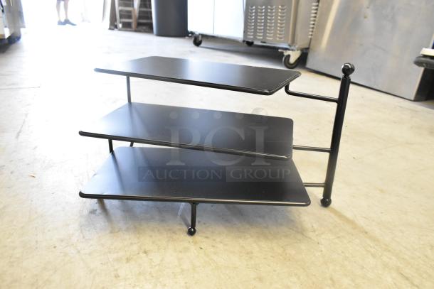 Brand new 3-tier rack with minor scratches; sturdy black metal and sleek design for efficient storage.