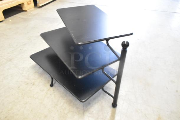 Three-tier black metal rack, brand new with minor scratches, sturdy design, perfect for storage or display.