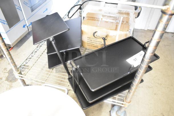 Brand new 3-tier black metal rack with slight scratches. Includes two units. Perfect for storage or display.