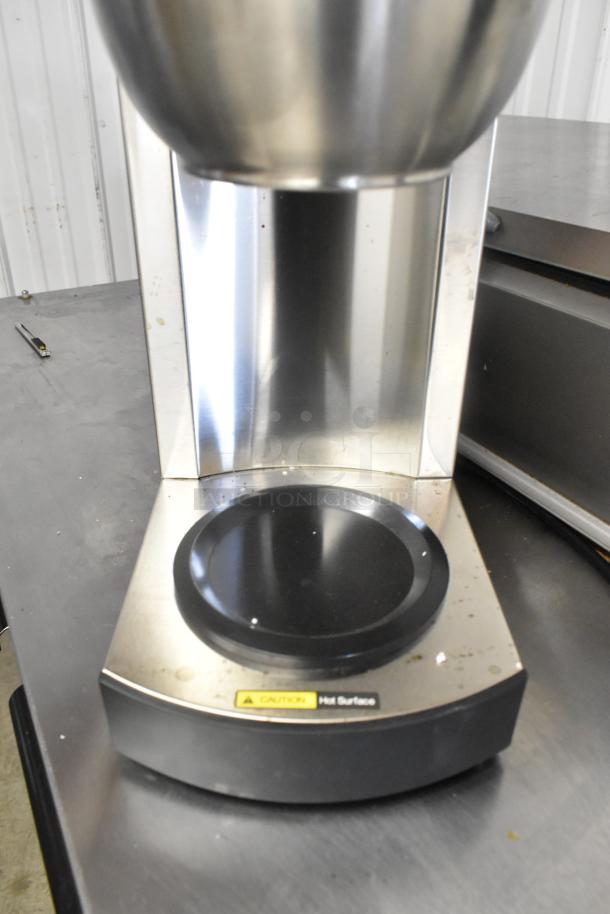 Brand new Avantco 177C10 12-cup commercial coffee maker with pourover design, two warmers, minor scratches visible.
