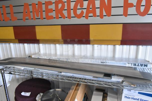 Three boxes of Matrix flooring, scratch and dent condition, stacked on a metal shelf. Brand new, labeled "Matrix."