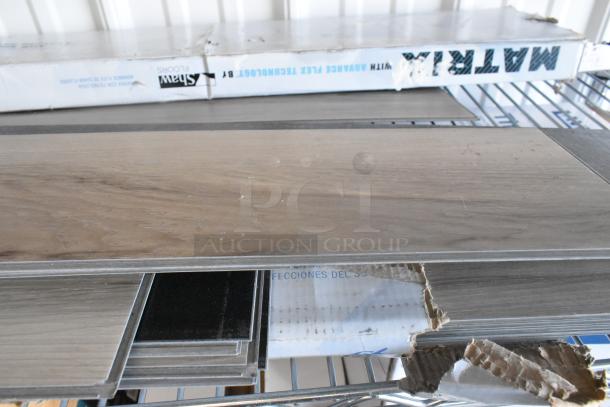Three boxes of Matrix flooring, brand new scratch and dent condition, featuring wood-like finish, visible packaging wear.