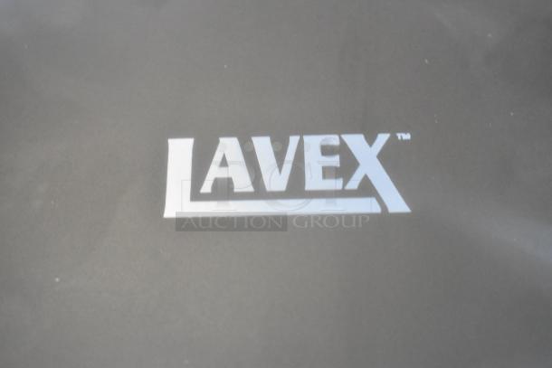 Black Lavex KW-1021B stainless steel automatic hand dryer, brand new, with visible minor scratches and dents, logo shown.
