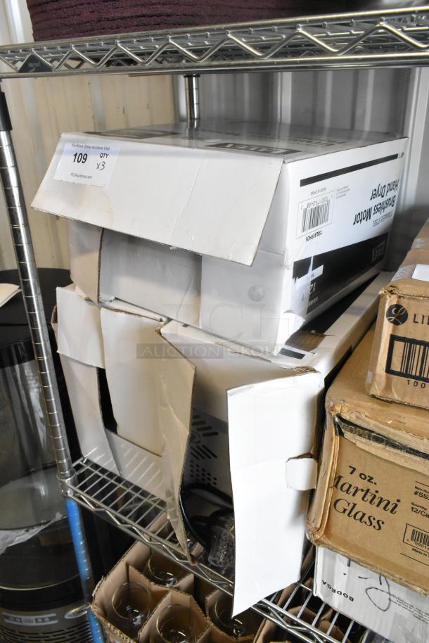 Three Lavex Pro automatic hand dryers with HEPA filtration in damaged boxes, includes satin, black, and white models.